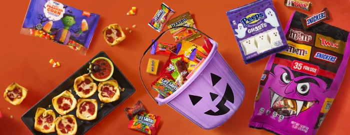 kroger halloween Halloween candy and treats spread on orange background.